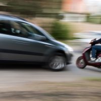 Speeding car accident about to happen with blurred speeding car and motorcycle
