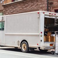 White color truck delivering packages, Manhattan downtown