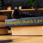 Pile of books, gavel and Wrongful death lawsuit.