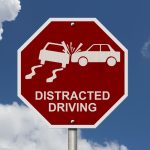 No Distracted Driving Sign, Red stop sign with words Distracted Driving and accident icon with sky background