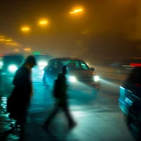 blurry-city-scene-at-night-with-cars-and-pedestrians-on-a-foggy-street blurry-city-scene-at-night-with-cars-and-pedestrians-on-a-foggy-street