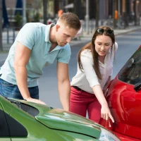 woman-showing-man-car-collision woman-showing-man-car-collision